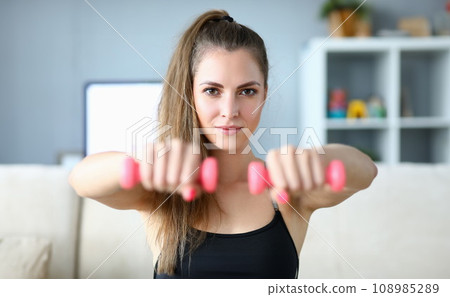Perfect girl holding dumbbells Perfect girl holding dumbbells 108985289