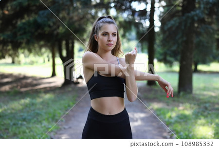 Pretty girl having sport in park 108985332
