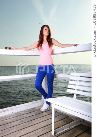 The young happy woman on sea The young happy woman on sea 108985419