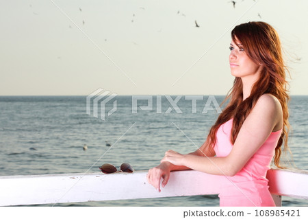The young happy woman on sea 108985421