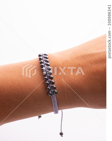 Black hematite handmade bracelet on white background Black hematite handmade bracelet on white background 108986341