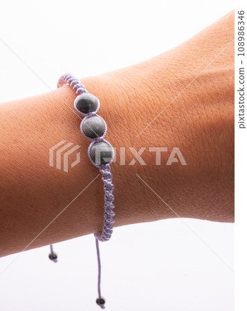 Collection of crystal gemstones bracelets on the table. 108986346