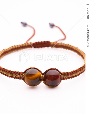 Tiger Eyes Stone Bracelet on the stump wood Tiger Eyes Stone Bracelet on the stump wood 108986501