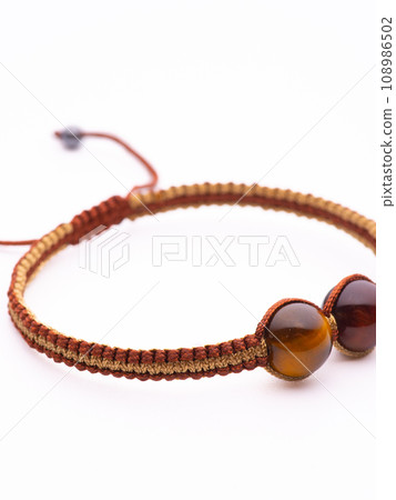 Tiger Eyes Stone Bracelet on the stump wood Tiger Eyes Stone Bracelet on the stump wood 108986502