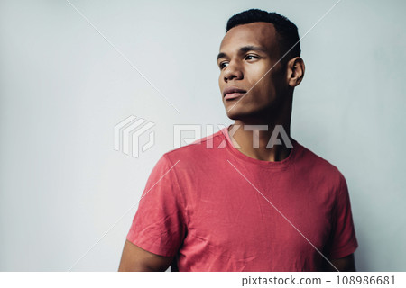 Pondering hipster guy holding modern cellular gadget in hands and thoughtful looking aside, 108986681