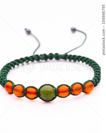 Collection of crystal gemstones bracelets on the table. 108986795