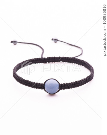 Collection of crystal gemstones bracelets on the table. 108986816