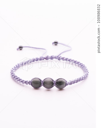 Collection of crystal gemstones bracelets on the table. 108986832
