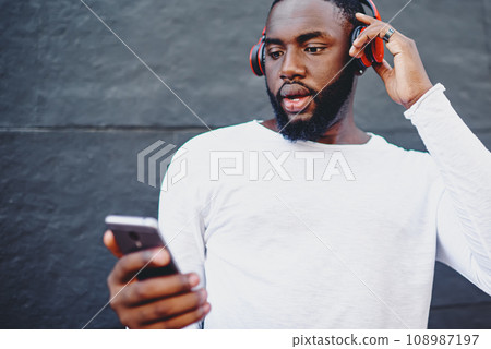 Male meloman searching new audio songs on content website feeling shocked from application price Male meloman searching new audio songs on content website feeling shocked from application price 108987197