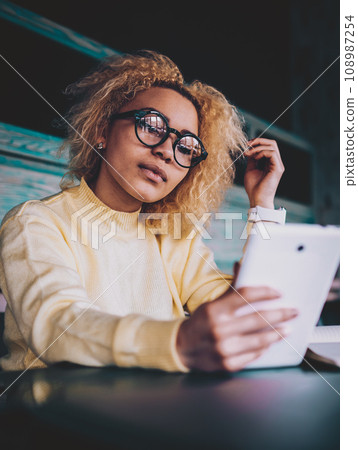 Attractive dark skinned female hipster in spectacles for provide eyes protection updating profile Attractive dark skinned female hipster in spectacles for provide eyes protection updating profile 108987254