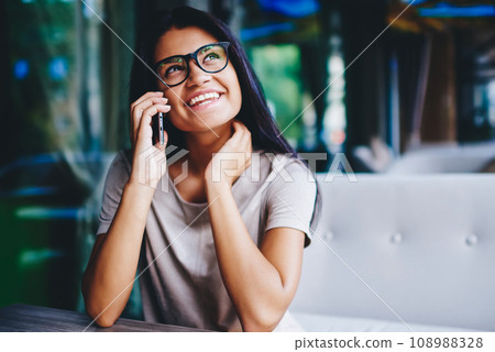 carefree hipster girl satisfied with good connection and payment for making telephone calls carefree hipster girl satisfied with good connection and payment for making telephone calls 108988328