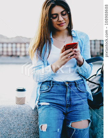 Attractive female blogger updating profile in app using free 4G internet connection 108988688