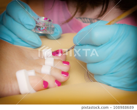 Master does a pedicure in a beauty salon. Close up. 108988689
