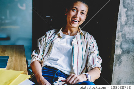 smiling woman blogger laughing on funny idea for article in office smiling woman blogger laughing on funny idea for article in office 108988758