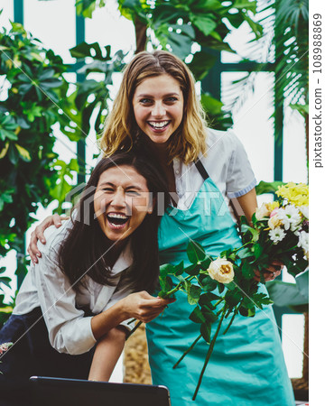 satisfied employees of orangery creating looking at camera in warmhouse satisfied employees of orangery creating looking at camera in warmhouse 108988869