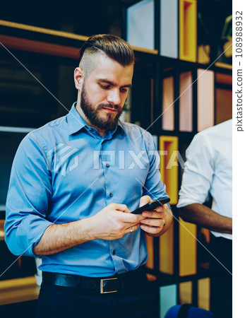 Employees searching information on website on cellular Employees searching information on website on cellular 108988932