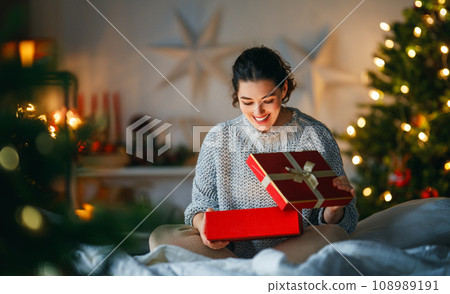 woman with Christmas present woman with Christmas present 108989191