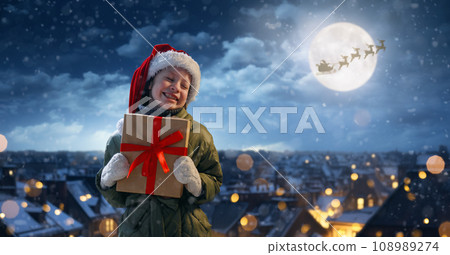girl with present at Christmas girl with present at Christmas 108989274