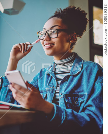 Positive contemplative hipster girl in stylish eyewear for vision correction looking away 108989318