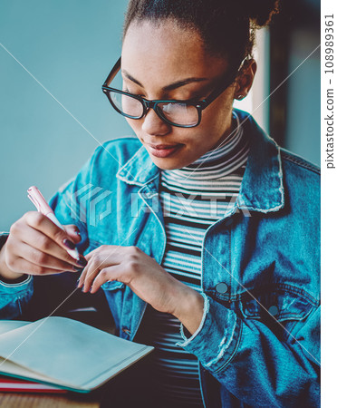 dark skinned hipster girl learning and preparing to university exams 108989361