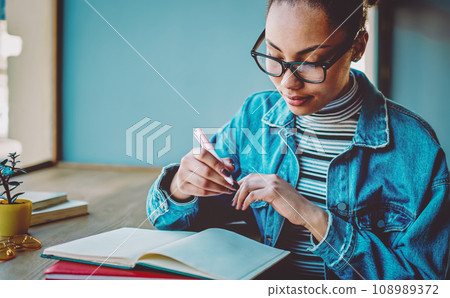 dark skinned hipster girl learning and preparing to university exams 108989372