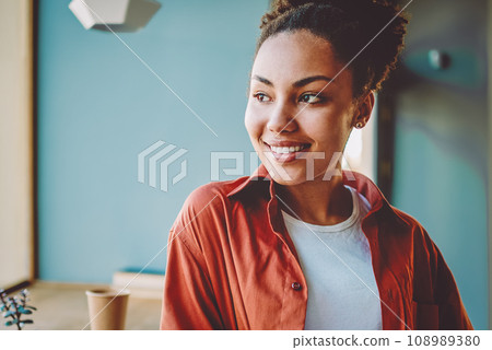 happy dark skinned woman holding textbook for education 108989380
