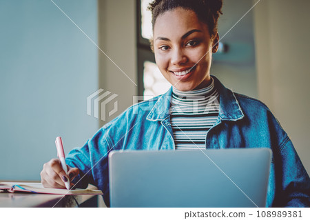 happy hipster girl research information for college course work using laptop device 108989381