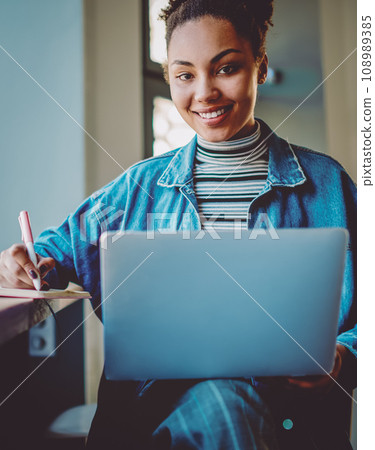 happy hipster girl research information for college course work using laptop device 108989385