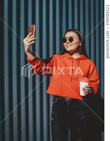 happy smiling hipster girl spending time for creating new images content via cellphone happy smiling hipster girl spending time for creating new images content via cellphone 108989521