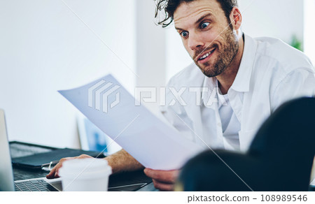 confused caucasian businessman stressed with financial report confused caucasian businessman stressed with financial report 108989546