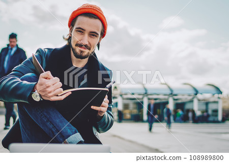 handsome hipster guy holding sketchbook for designing in hands 108989800