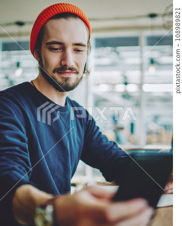 positive hipster guy checking notification on cellular phone positive hipster guy checking notification on cellular phone 108989821
