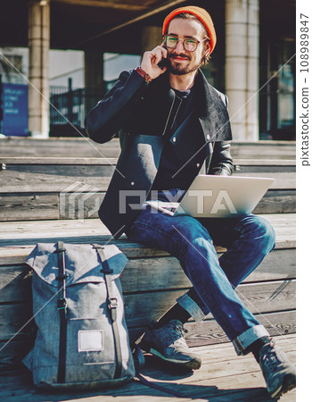 male looking at camera while communicate via cellular 108989847