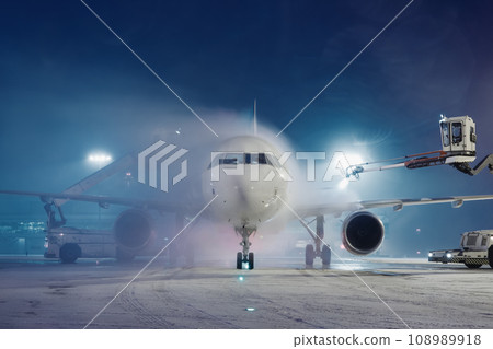 Deicing of airplane at airport. 108989918