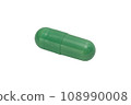A pill of green color isolated on a white background. Macro. 108990008