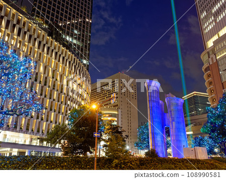 Evening view in front of Osaka Station Umeda ventilation tower illuminated 108990581