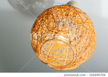 Modern chandelier with ball shaped straw lampshade 108990704