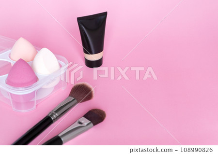 Beauty blender or make up sponge, tone cream and makeup brush on pink background. Cosmetic tool,beauty accessories. Copy space. Beauty blender or make up sponge, tone cream and makeup brush on pink background. Cosmetic tool,beauty accessories. Copy space. 108990826