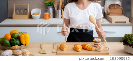 Happiness beautiful young asian woman in apron while preparing food while relaxation. 108990985