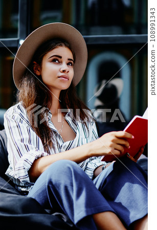attractive hipster girl pondering on information spending time on hobby outdoors 108991343