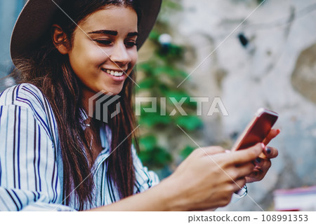 successful female blogger satisfied with feedbacks from followers working online via cellular successful female blogger satisfied with feedbacks from followers working online via cellular 108991353