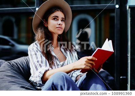 attractive hipster girl pondering on information spending time on hobby outdoors 108991360