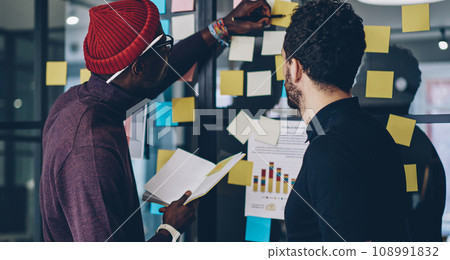 skilled men colleagues working on report together consulting share ideas skilled men colleagues working on report together consulting share ideas 108991832