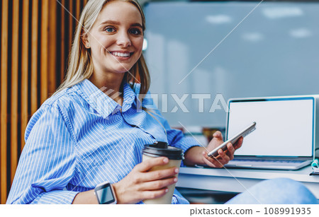 .Cheerful hipster blogger chatting on cellular in office .Cheerful hipster blogger chatting on cellular in office 108991935