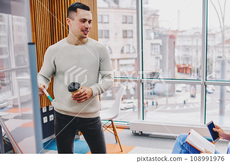 Two designers discussing ideas for project 108991976