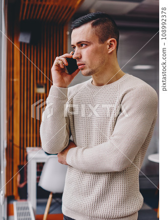 Confident male manager calling on cellular Confident male manager calling on cellular 108992378