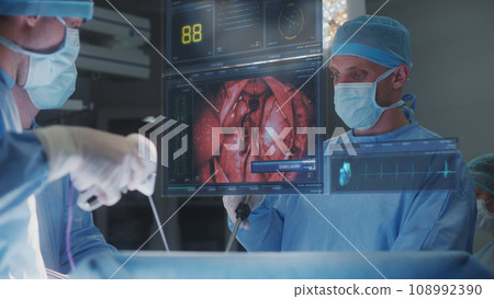 Surgeons operate patient using 3D hologram showing vital signs 108992390