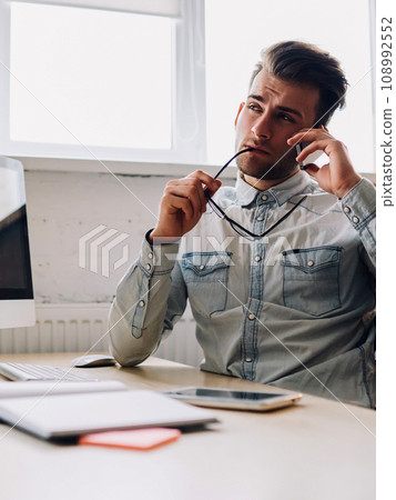 .Pondering manager calling on telephone .Pondering manager calling on telephone 108992552
