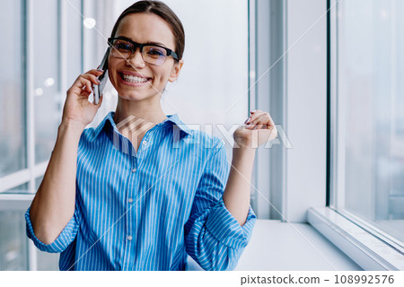 happy businesswoman inspectacles satisfied with success in business making call 108992576