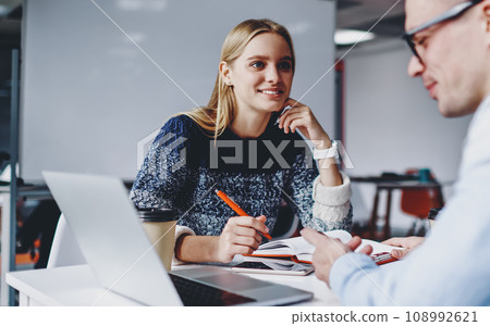 .Two successful students discussing design for website 108992621